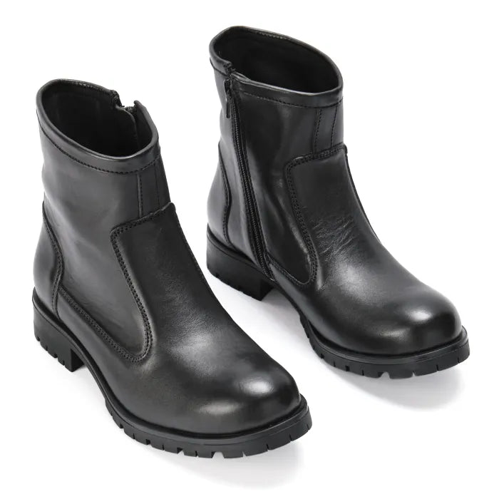 Pair of black leather boots on a white background