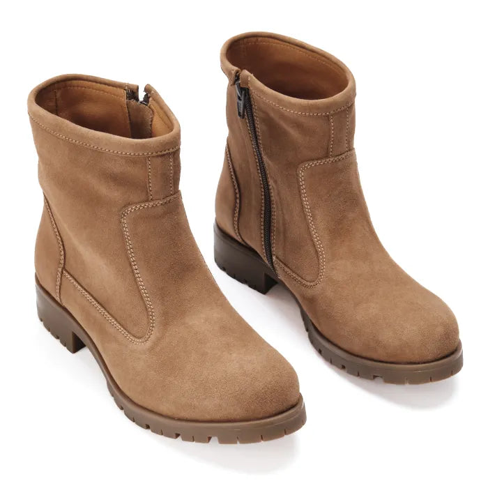 Pair of brown suede boots on a white background