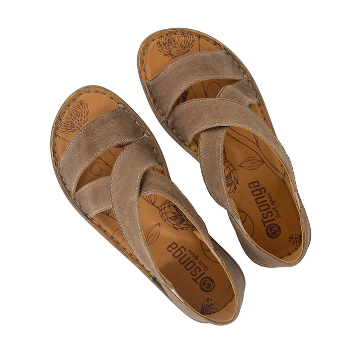 Beige sandal with criss-cross straps on a white background