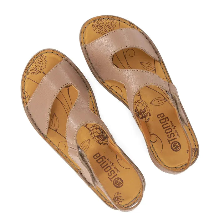 Pair of beige sandals with floral patterns on a white background