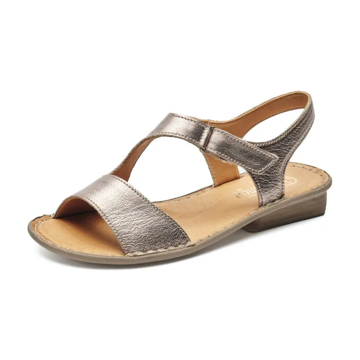 A metallic gold leather flat sandal with a T-strap design and a low wedge heel, shown from a three-quarters angle on a white background.