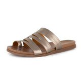 Gold sandal with multiple straps on a white background