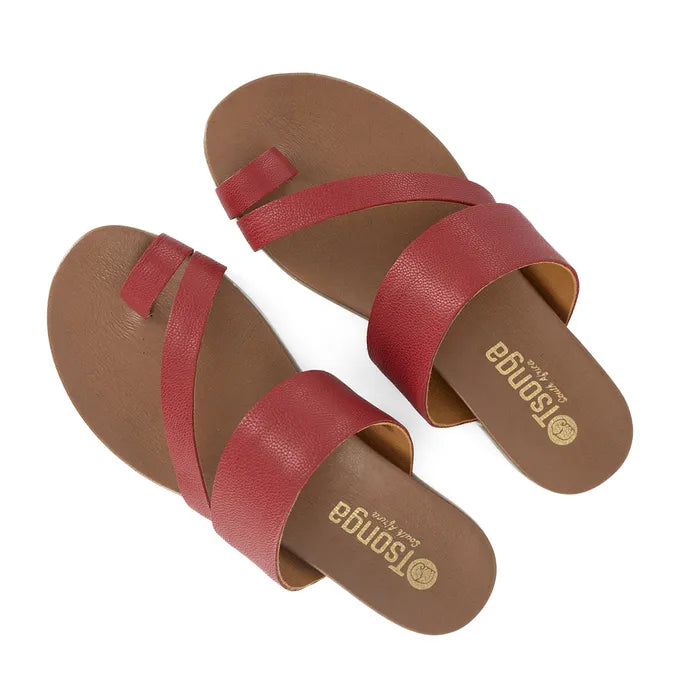 Red sandals with brown soles on a white background