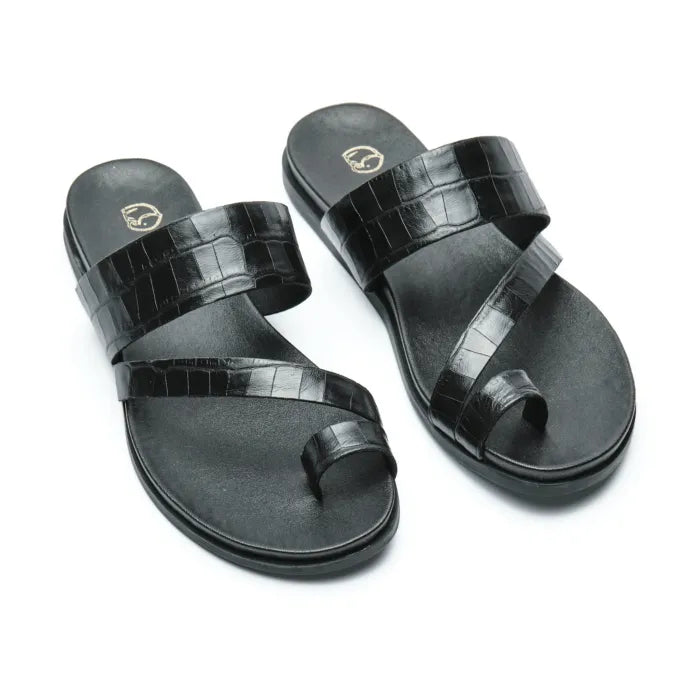 A pair of black sandals with 'Tsonga' branding on a white background