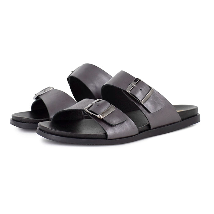 Pair of silver sandals with buckles on a white background