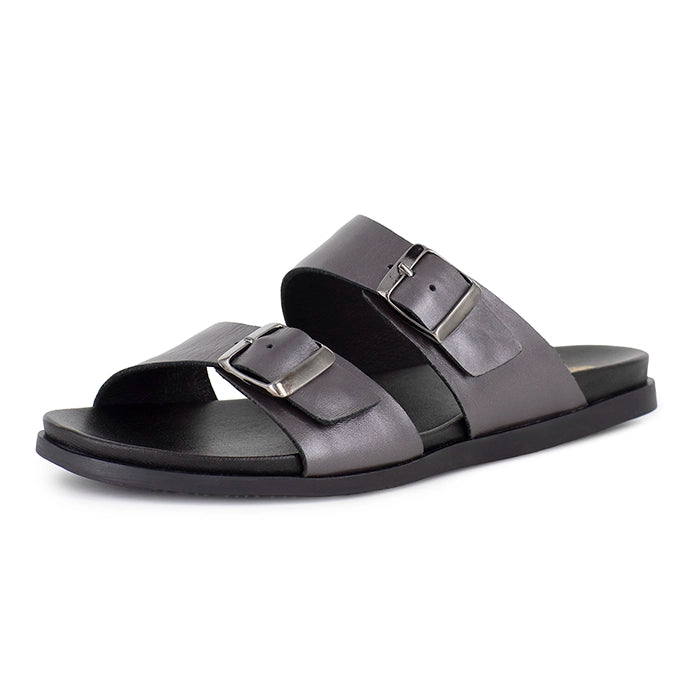 Pair of silver sandals with buckles on a white background