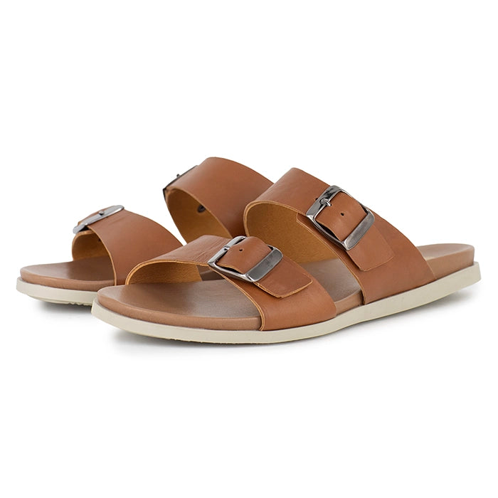 Pair of brown sandals with silver buckles on a white background