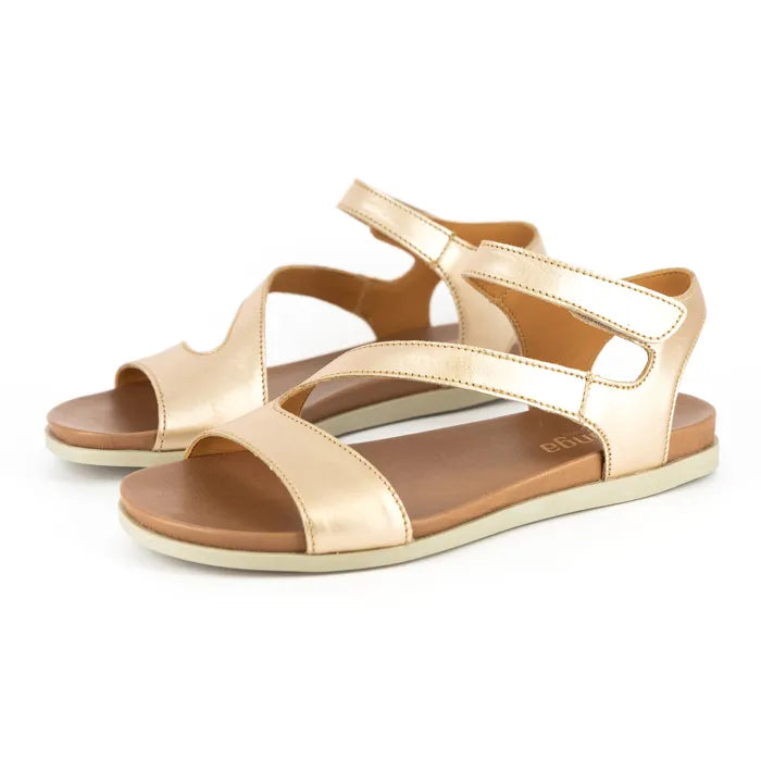 Pair of gold sandals on a white background