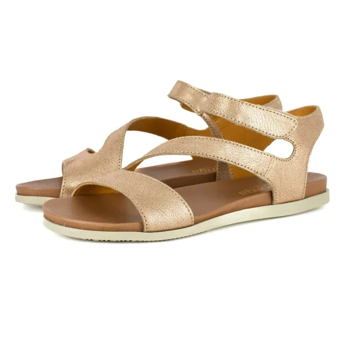 Gold sandals with brown soles on a white background