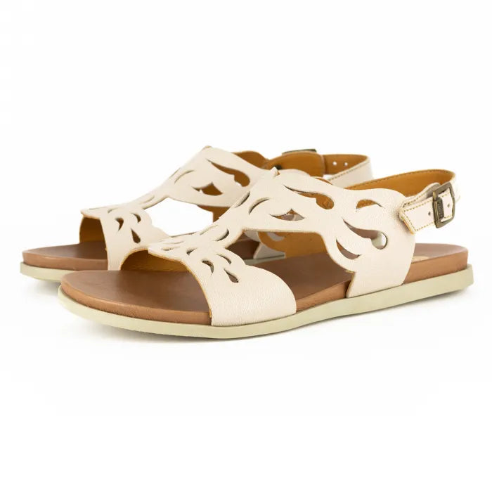 Pair of cream sandals with brown soles on a white background