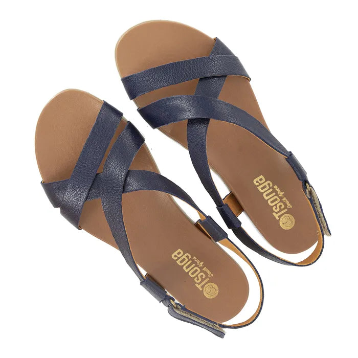 Pair of navy sandals with tan soles on a white background
