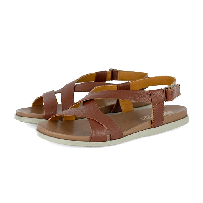 Pair of brown sandals with criss-cross straps on a white background