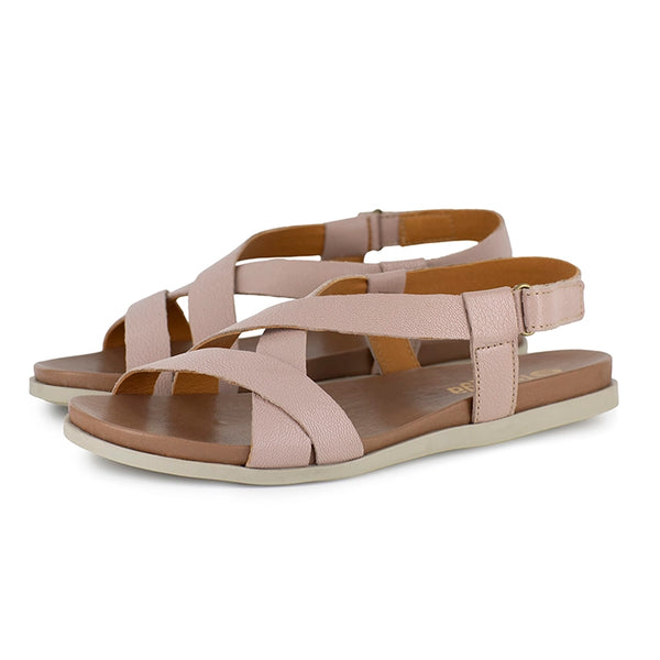 Pink sandals with criss-cross straps on a white background