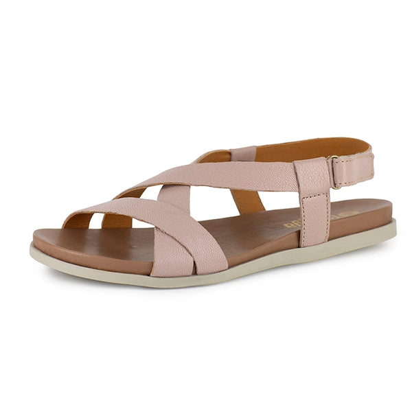 Pink sandal with criss-cross straps on a white background
