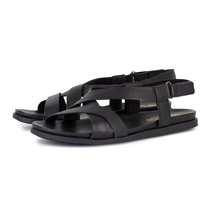 Black sandals with multiple straps on a white background