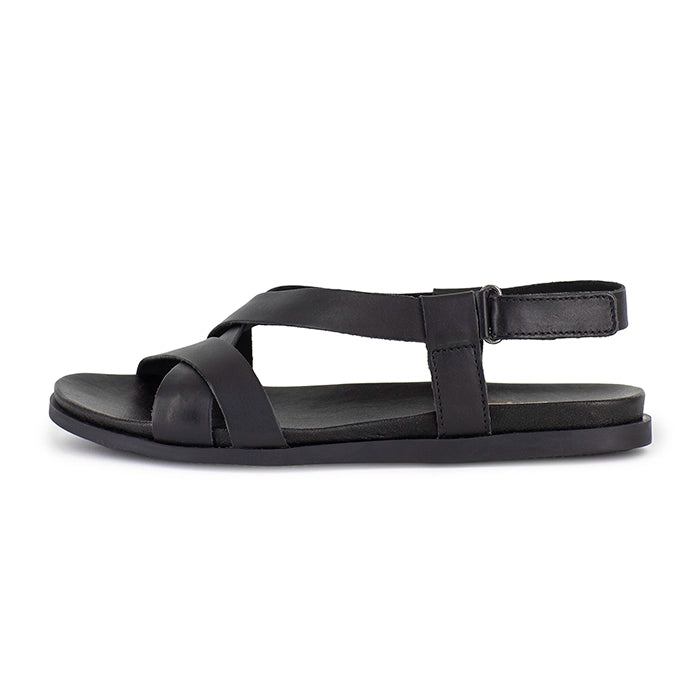 Black sandal with multiple straps on a white background