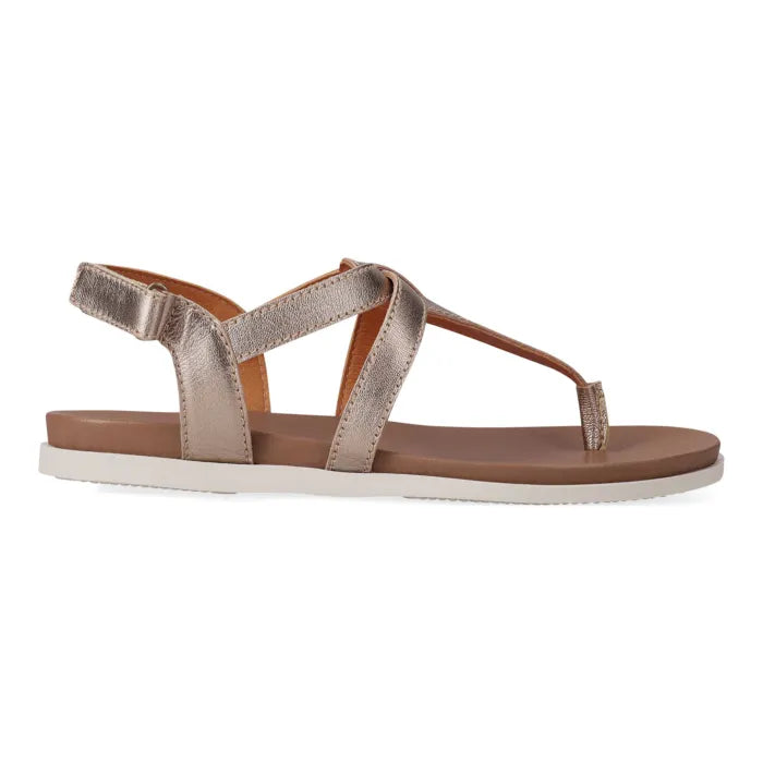 Gold sandal with a off white sole on a white background