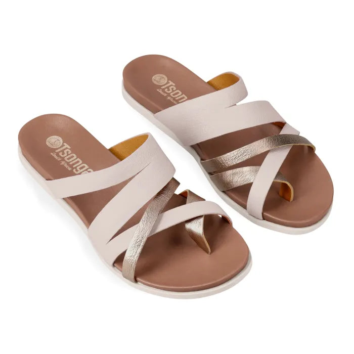 Pair of beige and metallic sandals with criss-cross straps on a white background