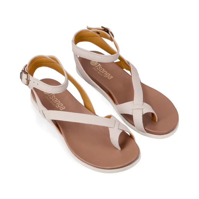 Pair of sandals with cream straps on a white background