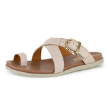 Beige sandal with a gold buckle on a white background