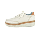 Cream sneaker with brown sole on a white background