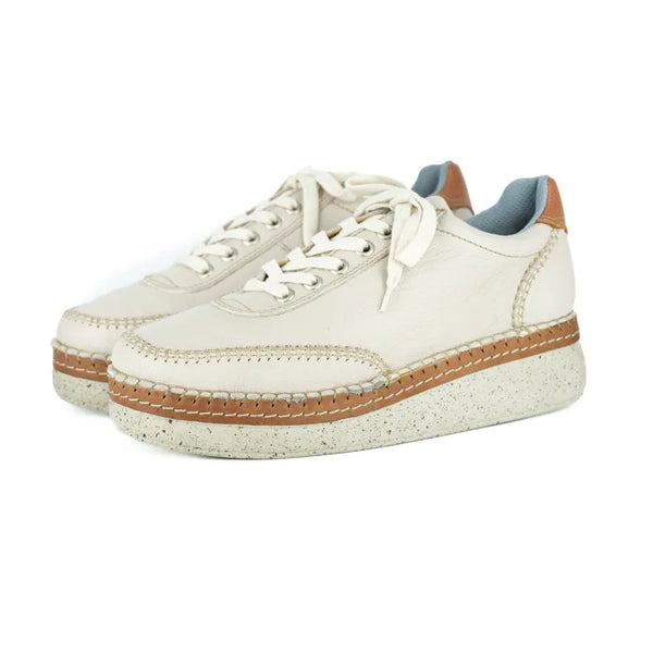 Cream sneakers with brown accents on a white background