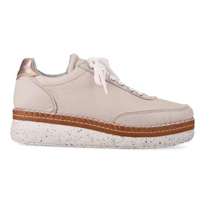 Beige sneaker with brown sole on a white background