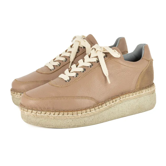Pair of beige sneakers with white laces on a white background