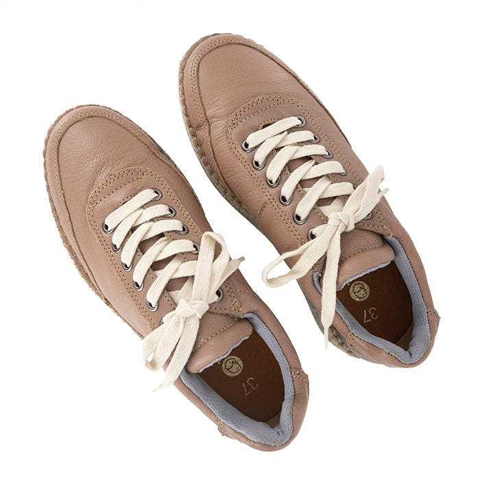 Pair of brown sneakers with white laces on a white background
