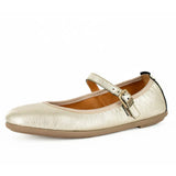 Gold metallic flat shoe with a strap on a white background