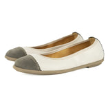 Pair of flat shoes with grey and cream colour scheme on a white background