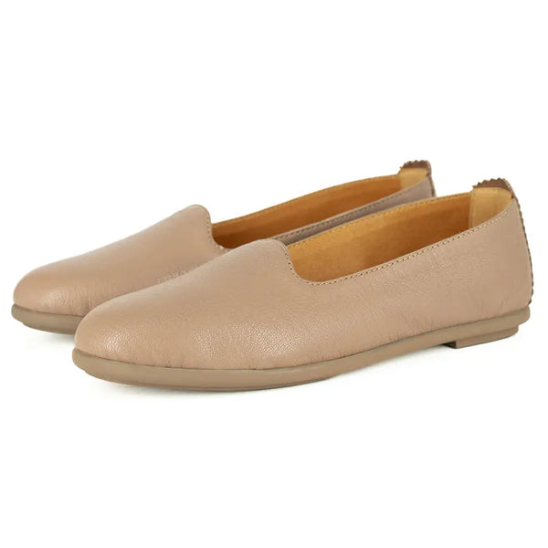 Pair of beige pumps on a white background