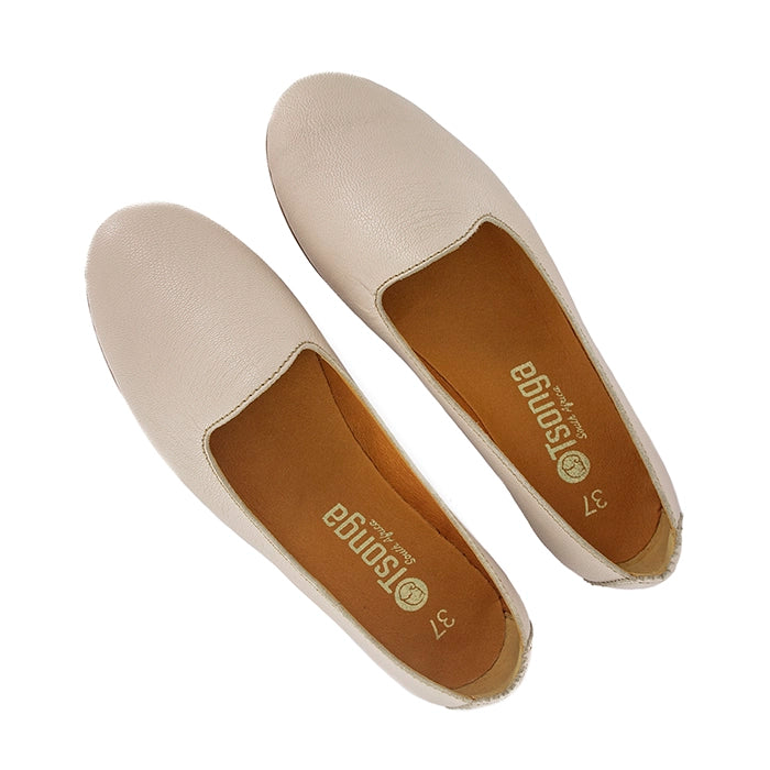 Pair of cream flat shoes with 'Tsonga' branding on a white background