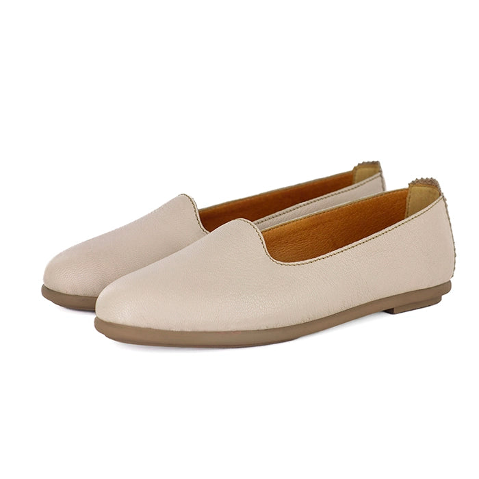 Pair of cream loafers on a white background