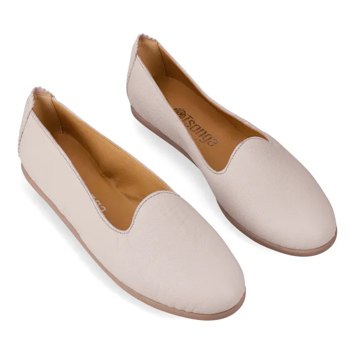Pair of beige flats with beige soles on a white background