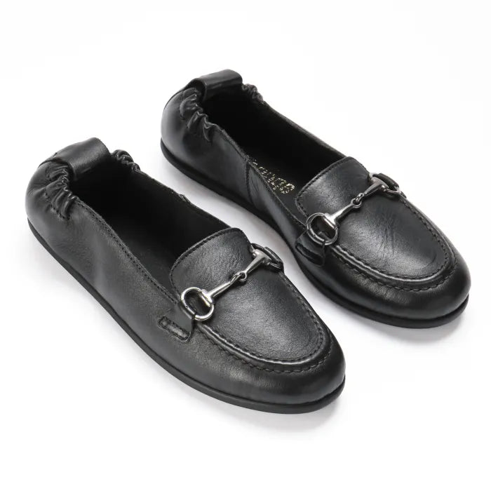 Pair of black leather loafers with metallic buckles on a white background