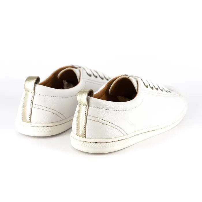 Pair of white sneakers with gold accents on a white background
