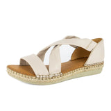 Beige sandal with criss-cross straps on a white background
