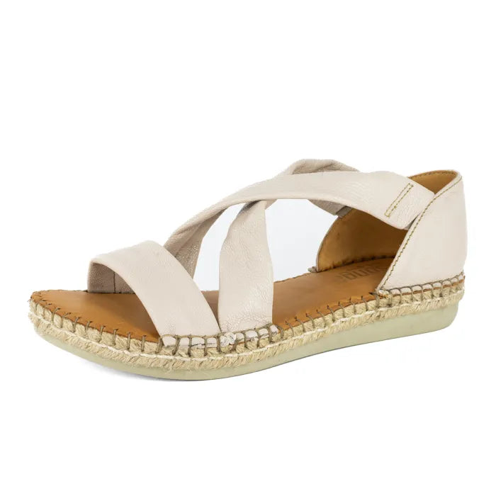 Beige sandal with criss-cross straps on a white background