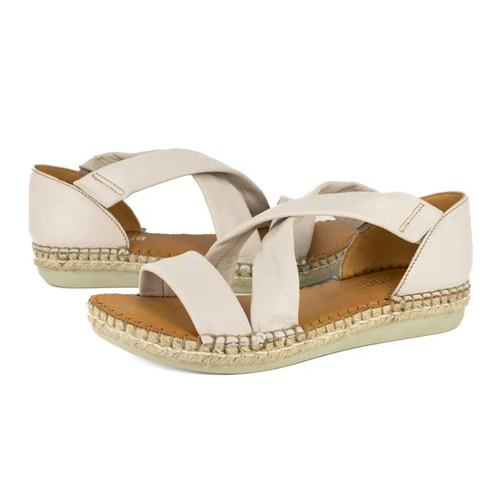 Pair of cream-colored sandals with espadrille sole on a white background