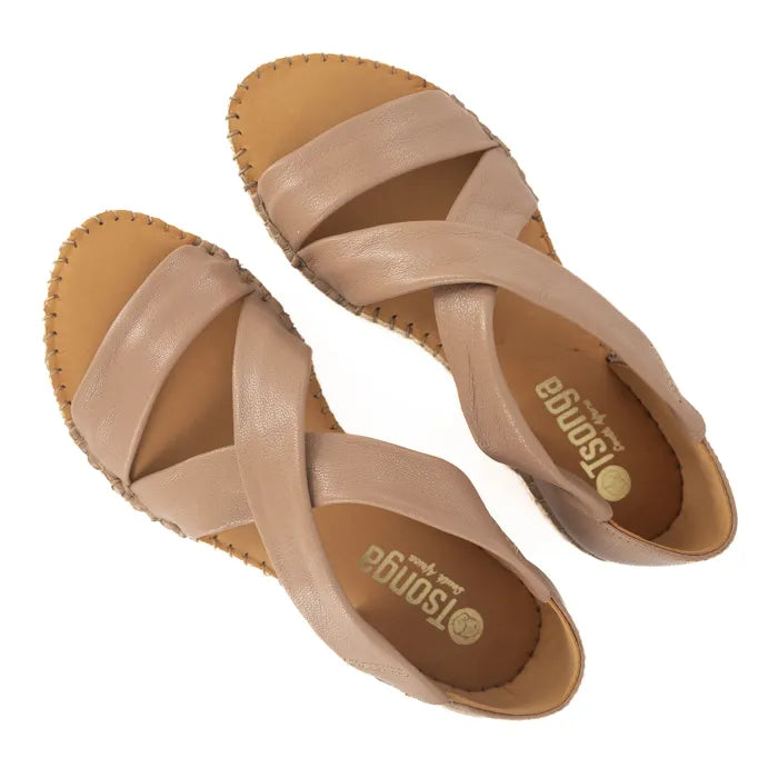 Pair of beige sandals with criss-cross straps on a white background