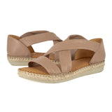 Pair of beige sandals with woven sole on a white background