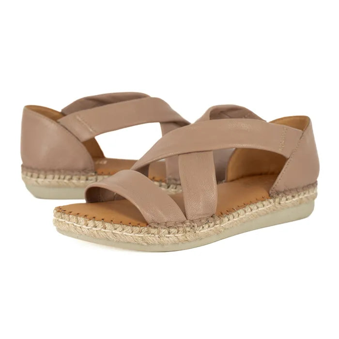 Pair of beige sandals with woven sole on a white background