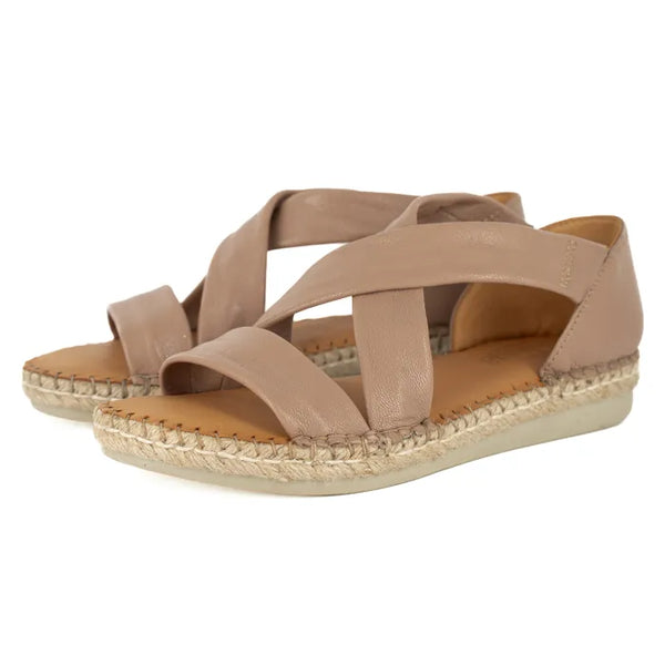 Pair of beige sandals with espadrille sole on a white background