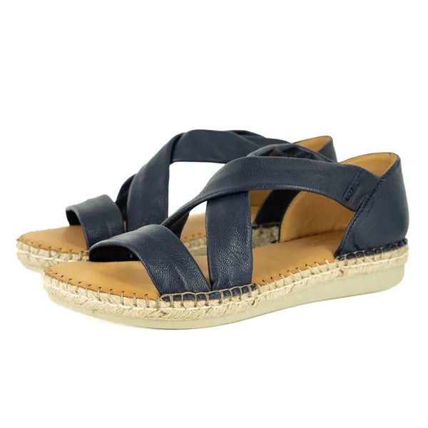 Navy blue sandals with woven sole on a white background