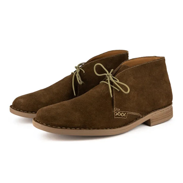 Pair of brown suede boots on a white background