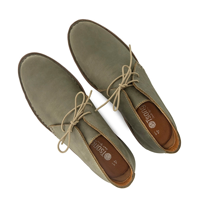 Pair of olive shoes with brown soles on a white background