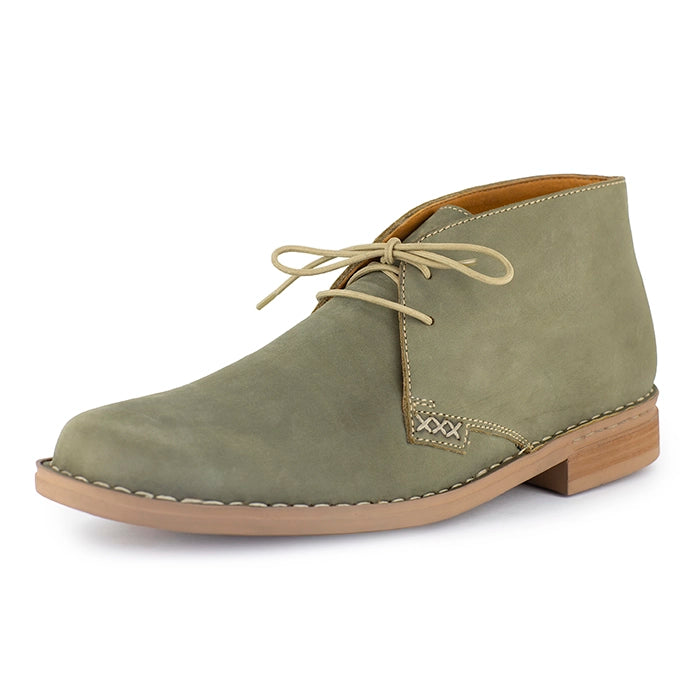 Olive suede shoe with brown sole on a white background