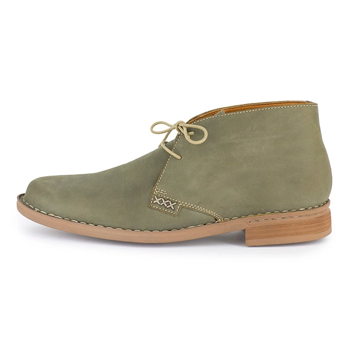 Olive suede shoe with brown sole on a white background
