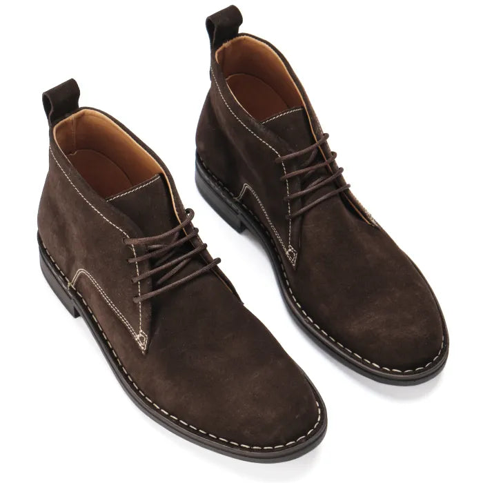 Pair of brown suede boots on a white background